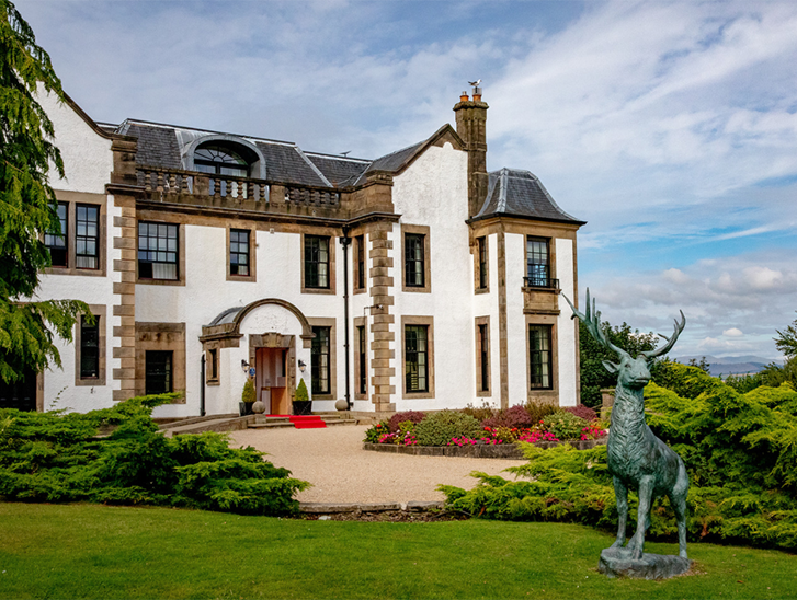 Gleddoch exterior with deer statue in foreground